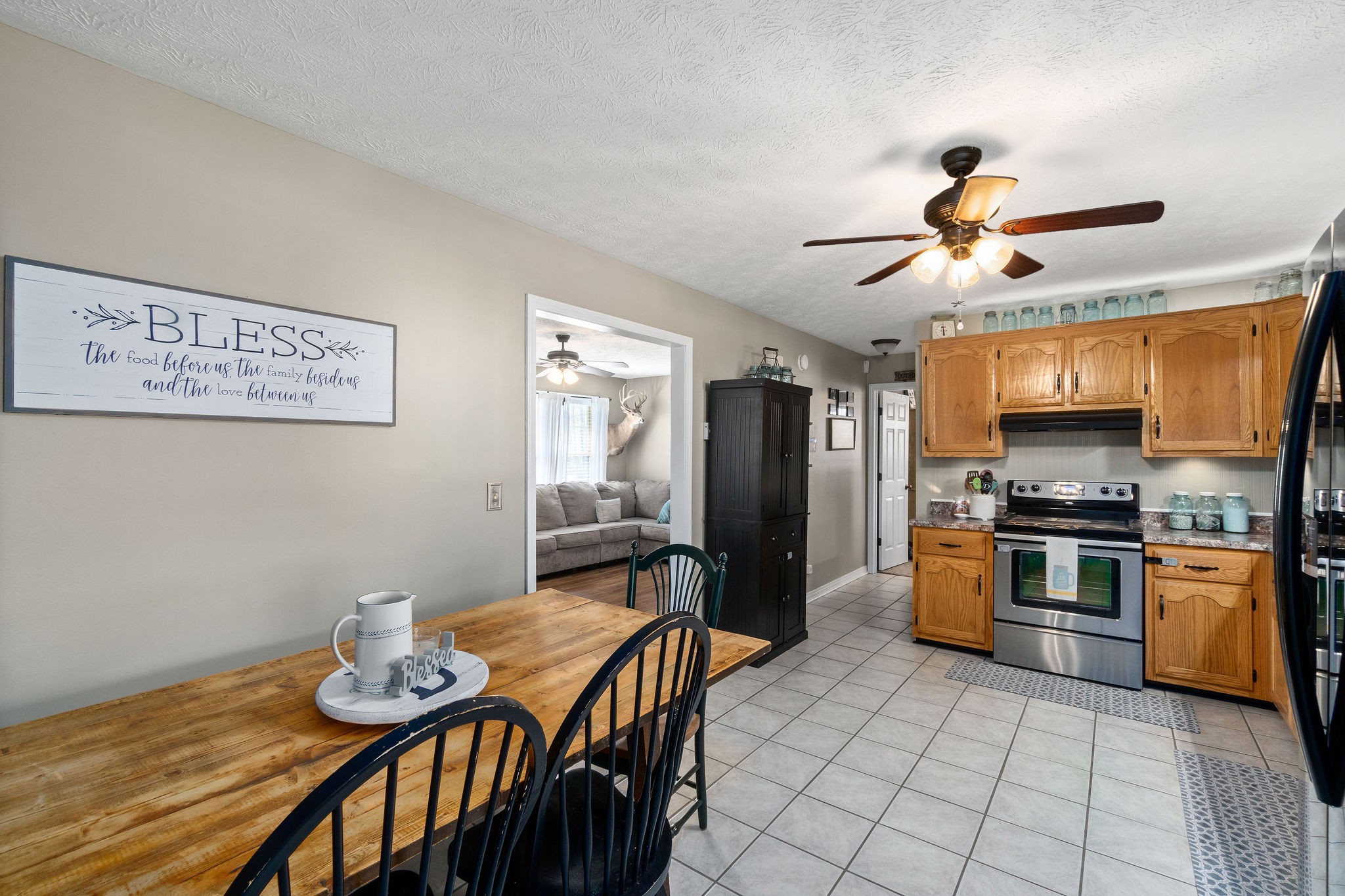 2868 Waverly Road Tennessee Ridge, TN 37178 - Photo 13 of 33 a kitchen with stainless steel appliances granite countertop a stove a sink dishwasher a refrigerator with a dining table and chairs