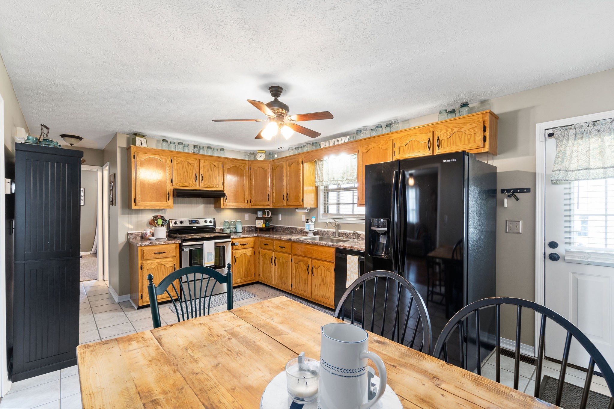 2868 Waverly Road Tennessee Ridge, TN 37178 - Photo 15 of 33 a kitchen with sink a refrigerator and chairs