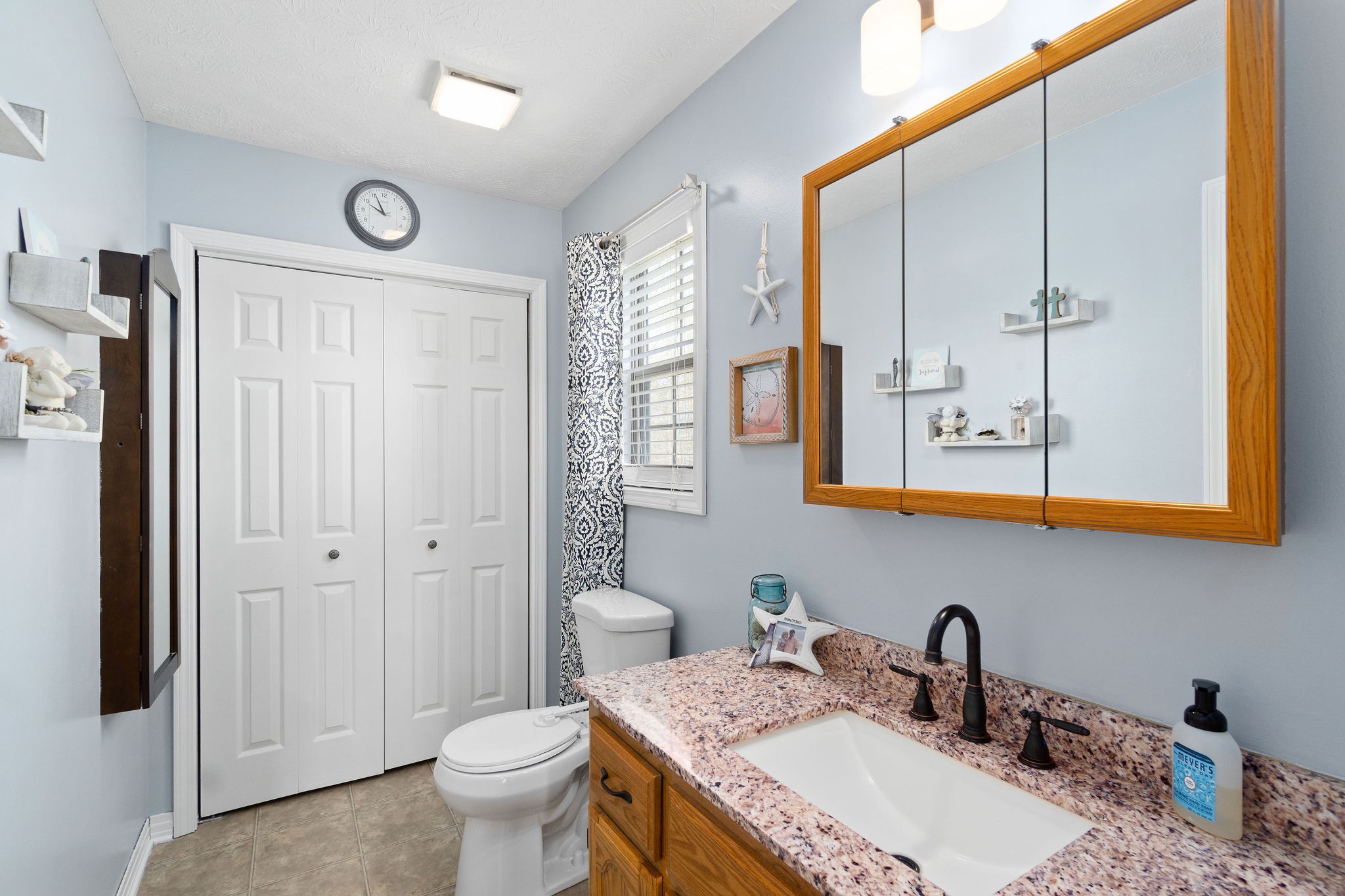 2868 Waverly Road Tennessee Ridge, TN 37178 - Photo 20 of 33 a bathroom with a granite countertop sink mirror vanity and toilet