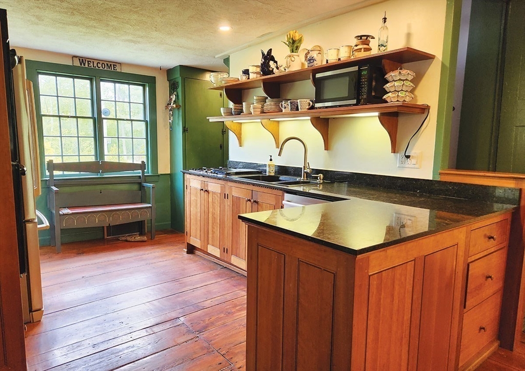 164 Worcester Road Westminster, MA 01473 - Photo 14 of 39 a kitchen with stainless steel appliances granite countertop a sink and a wooden cabinets