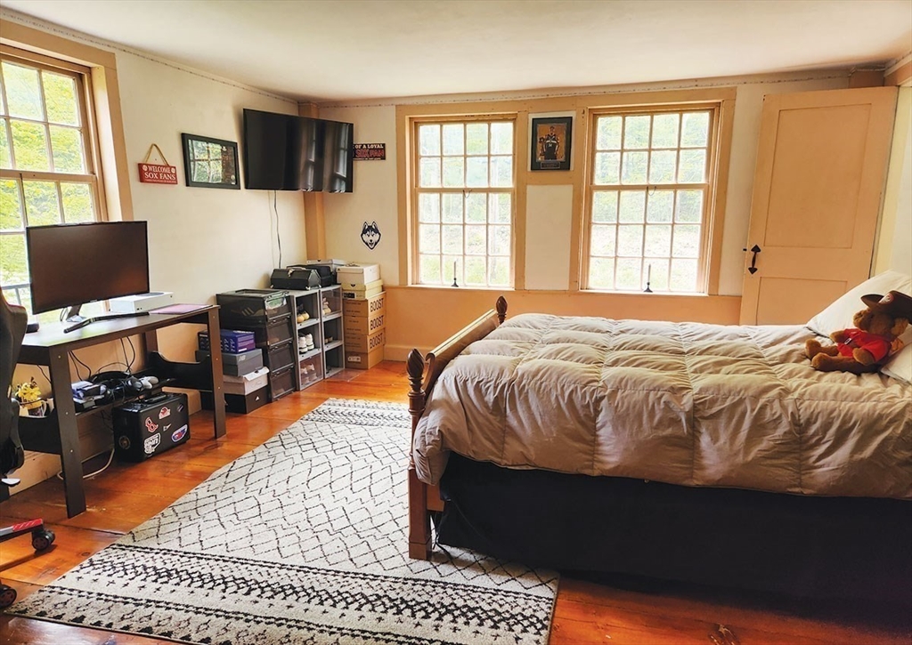 164 Worcester Road Westminster, MA 01473 - Photo 27 of 39 a bedroom with a bed and wooden floor