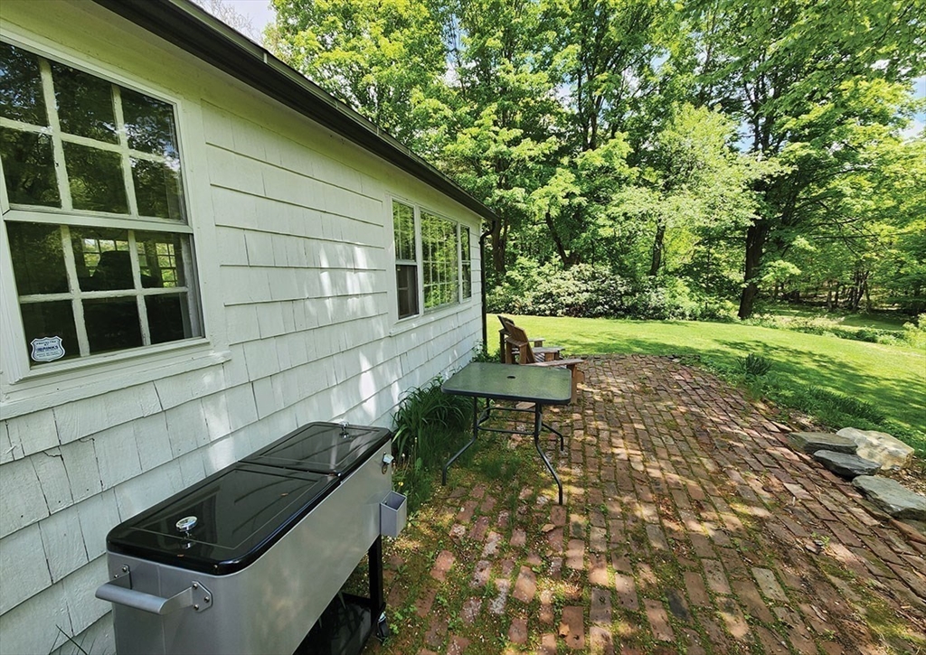 164 Worcester Road Westminster, MA 01473 - Photo 31 of 39 a view of backyard with seating space and trees in the background