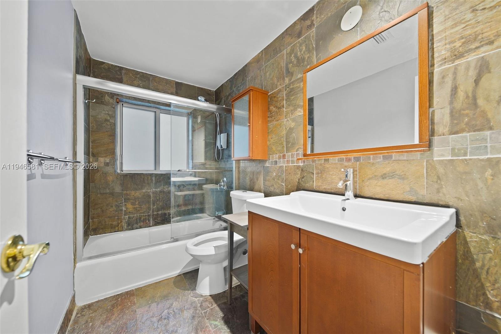 1145 101st Street, Unit 4 Bay Harbor Islands, FL 33154 - Photo 12 of 22 a bathroom with a sink a toilet and shower