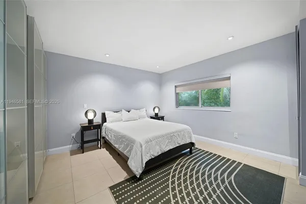 a bedroom with double bed and a window