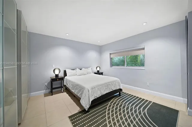 a bedroom with double bed and a window