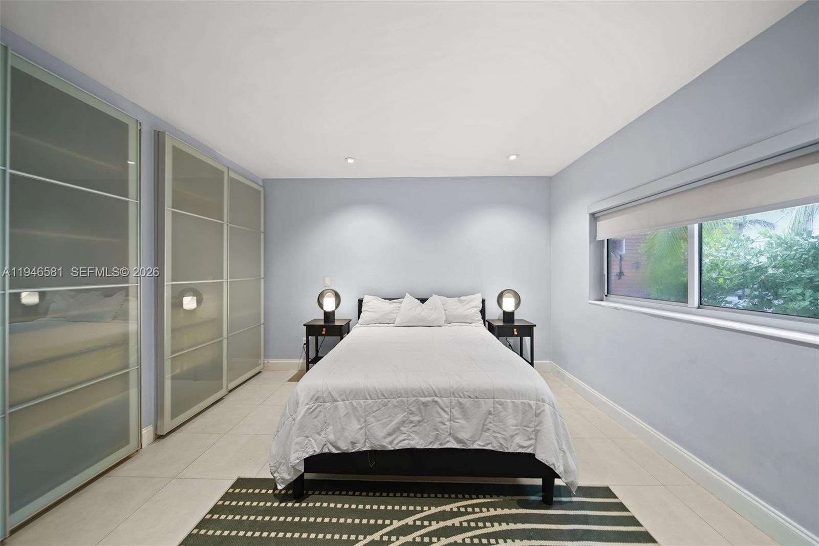 1145 101st Street, Unit 4 Bay Harbor Islands, FL 33154 - Photo 14 of 22 a bedroom with a bed and a window