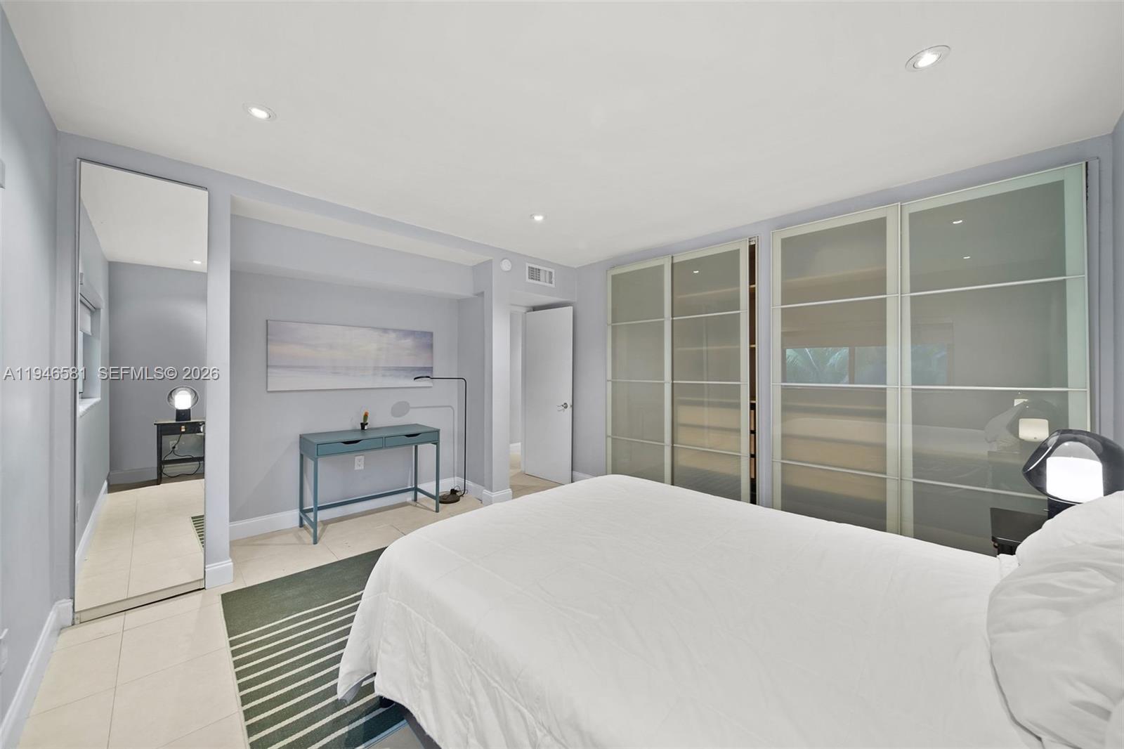 1145 101st Street, Unit 4 Bay Harbor Islands, FL 33154 - Photo 15 of 22 a bedroom with a bed and a large window