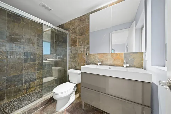 a bathroom with a sink toilet and shower