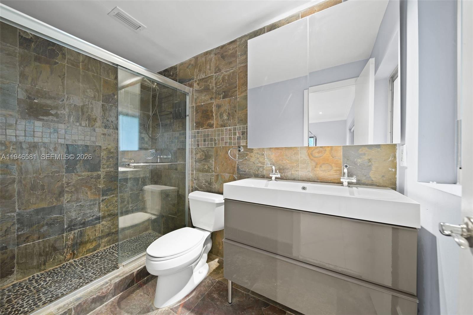 1145 101st Street, Unit 4 Bay Harbor Islands, FL 33154 - Photo 16 of 22 a bathroom with a sink toilet and shower