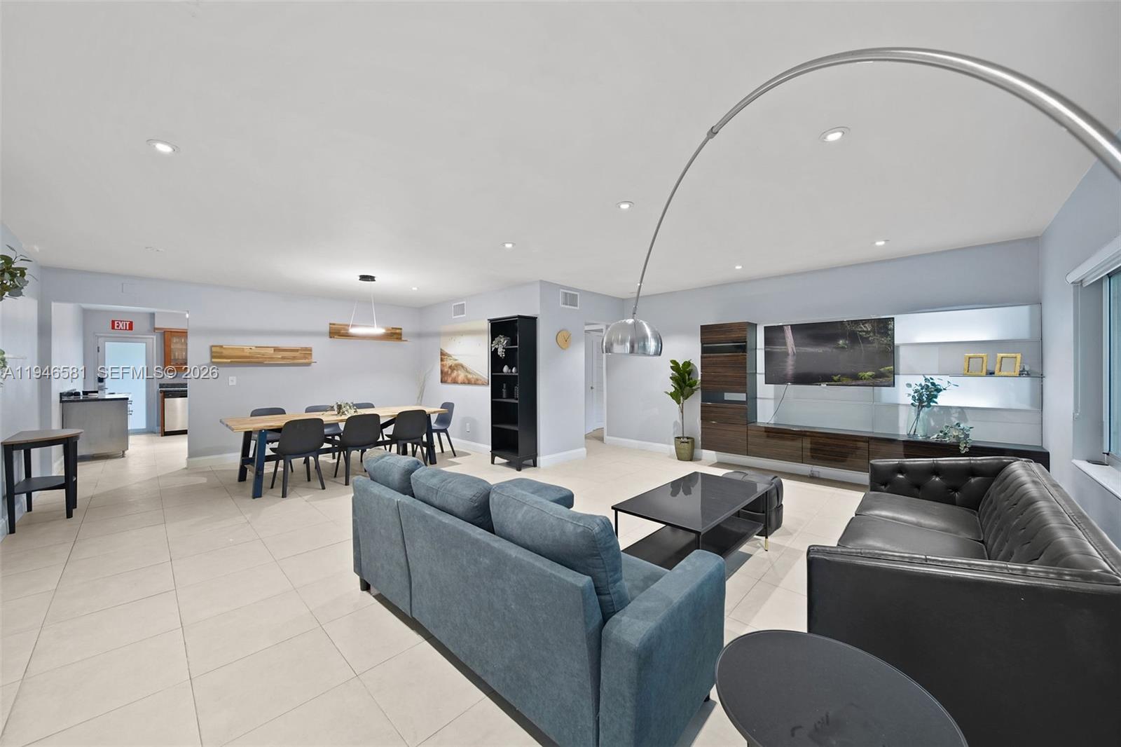 1145 101st Street, Unit 4 Bay Harbor Islands, FL 33154 - Photo 2 of 22 a living room with furniture and a flat screen tv
