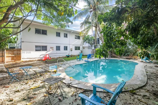 a view of a white house with a swimming pool