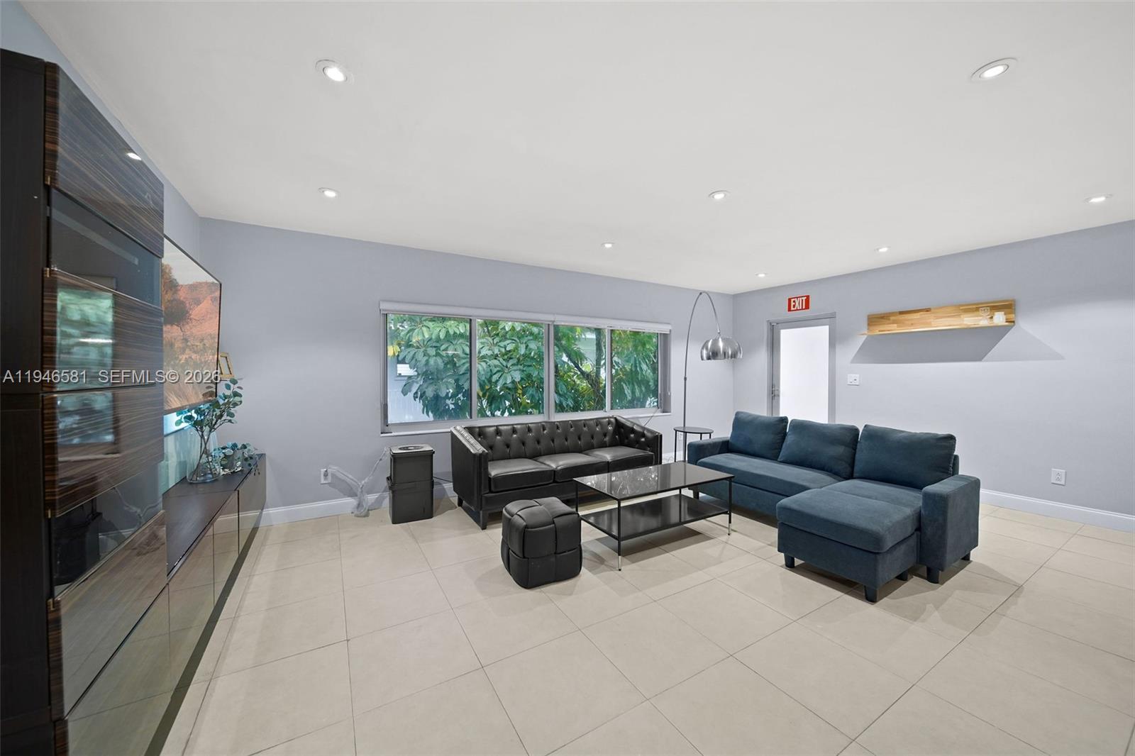 1145 101st Street, Unit 4 Bay Harbor Islands, FL 33154 - Photo 3 of 22 a living room with furniture and a large window