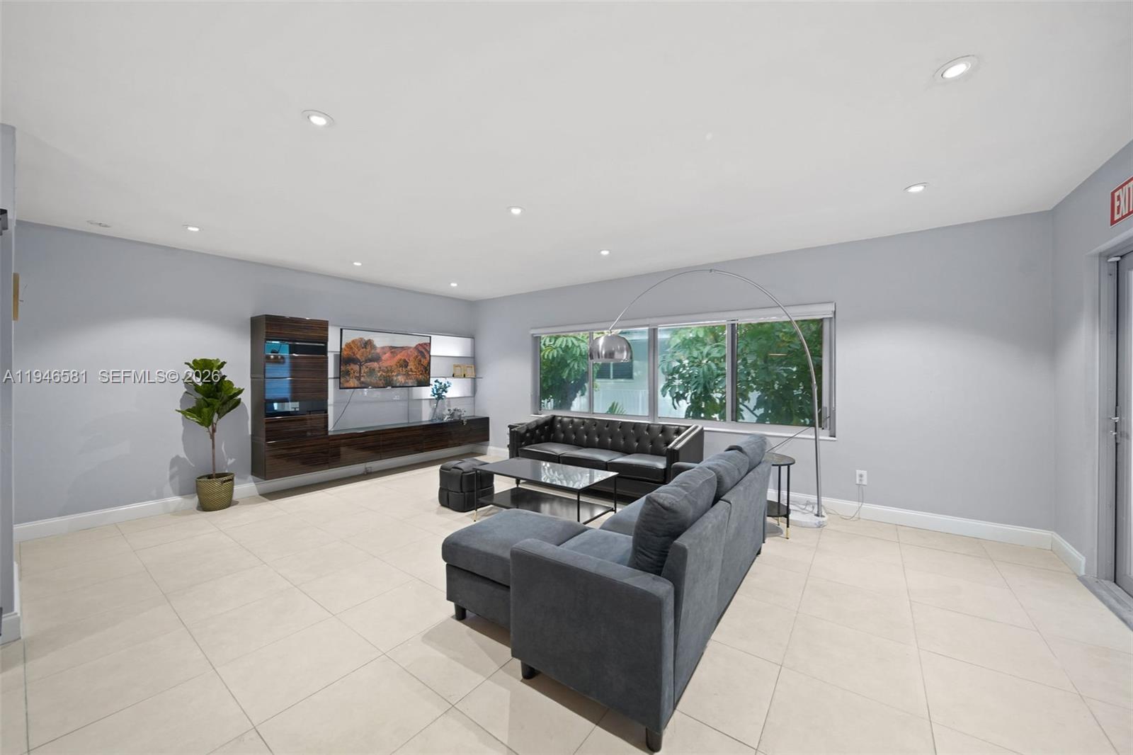 1145 101st Street, Unit 4 Bay Harbor Islands, FL 33154 - Photo 4 of 22 a living room with furniture and a flat screen tv