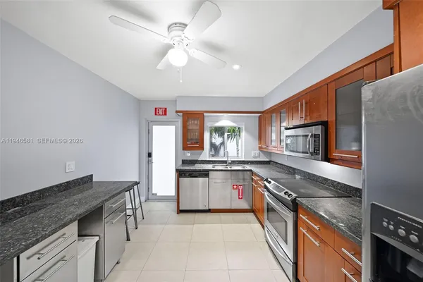 a kitchen with stainless steel appliances granite countertop a stove and a sink