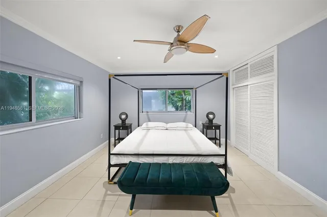 a living room with a bed furniture and a window