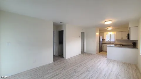 a view of a kitchen with a sink and a refrigerator