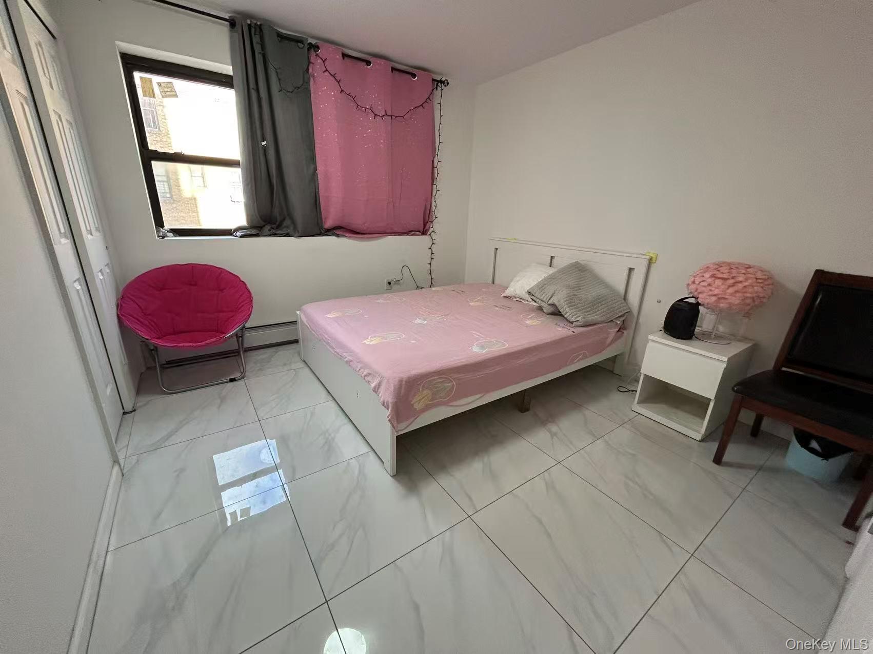 132-16 Maple Avenue, Unit 3A Queens, NY 11355 - Photo 4 of 10 a bedroom with a bed and a potted plant