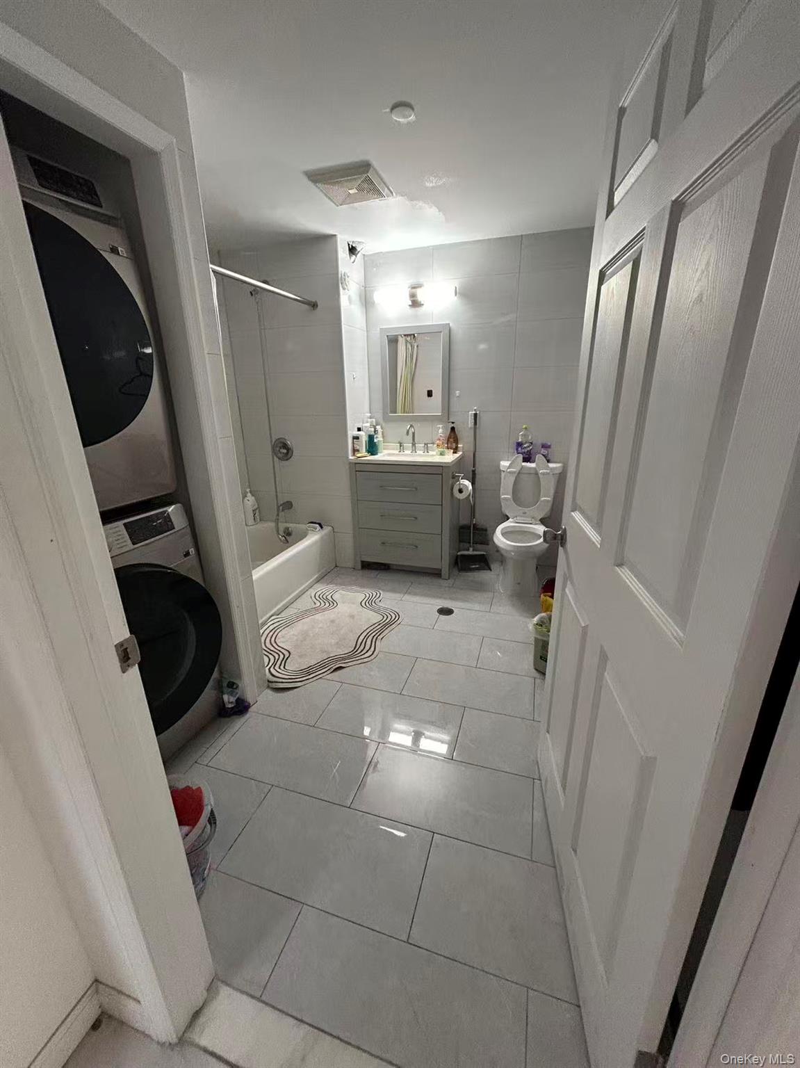 132-16 Maple Avenue, Unit 3A Queens, NY 11355 - Photo 8 of 10 a living room with furniture and a fireplace