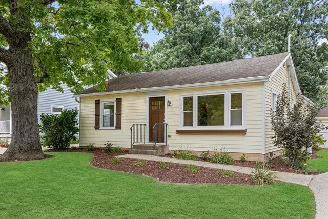 a front view of house with yard and green space