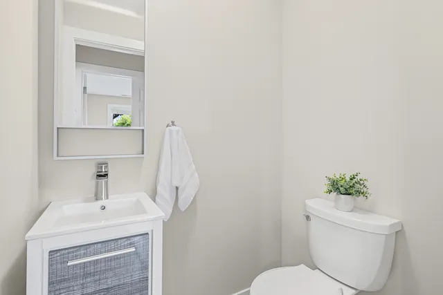 a bathroom with a sink a toilet and a mirror