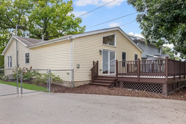 a view of a house with a yard and wooden fence