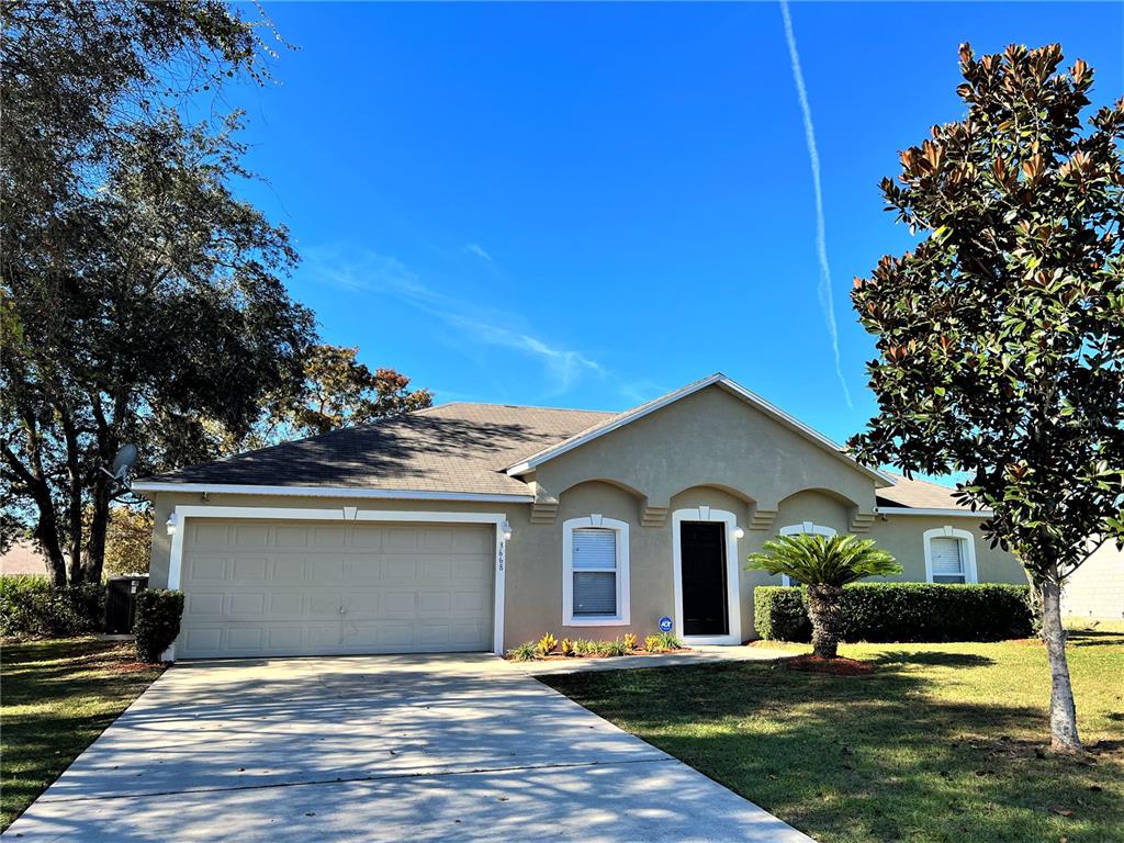 3668 Southwest 133rd Loop Ocala, FL 34473 - Photo 1 of 1 a view of a house with a yard and large tree