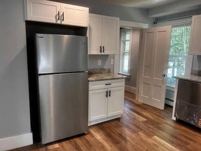 a white refrigerator freezer sitting in a kitchen