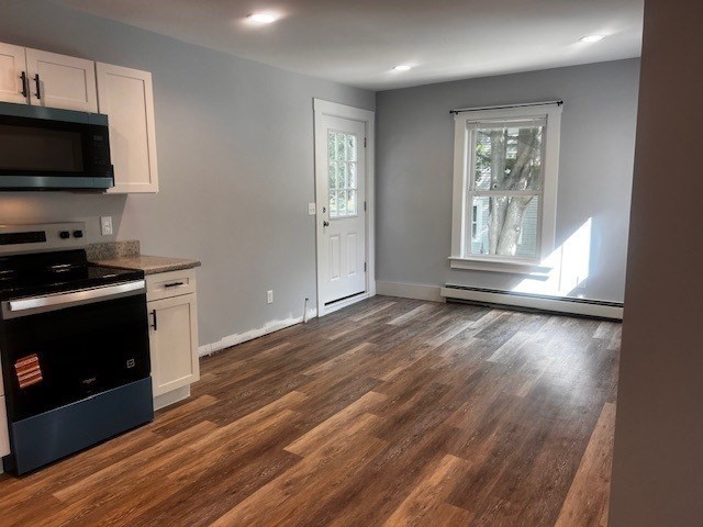 1 Madison Street, Unit B Amesbury, MA 01913 - Photo 5 of 17 a view of wooden floor and cabinets in a room