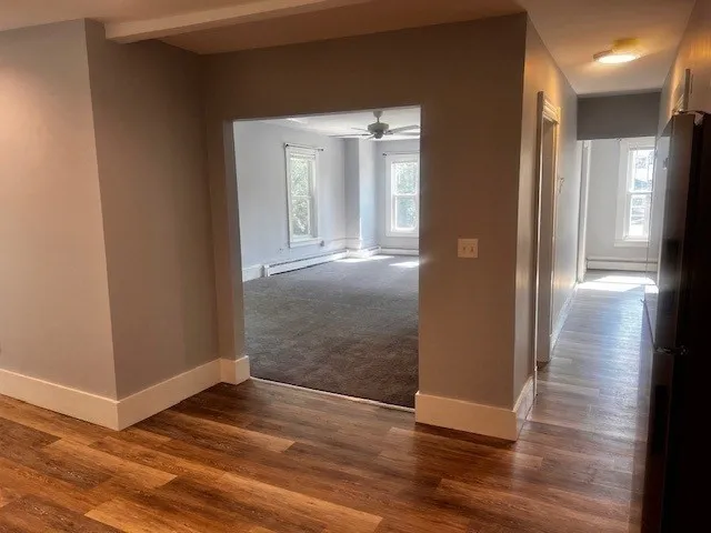 a view of a hallway with wooden floor