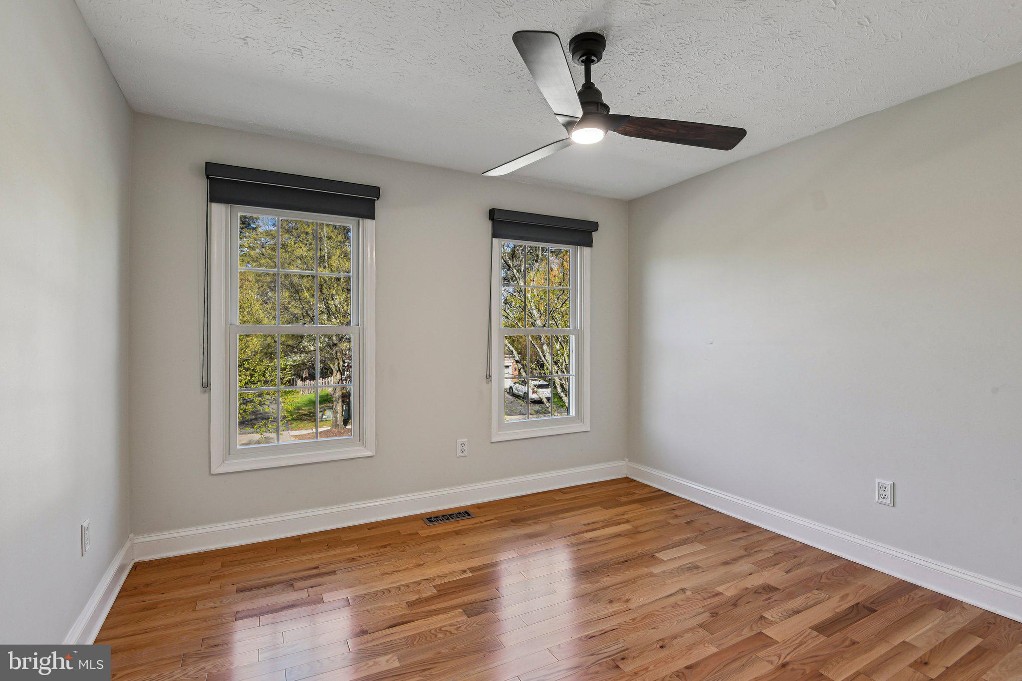 7617 Bear Forest Road Hanover, MD 21076 - Photo 18 of 37 a view of an empty room with window and wooden floor