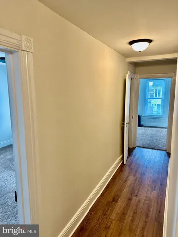 a view of a room with wooden floor