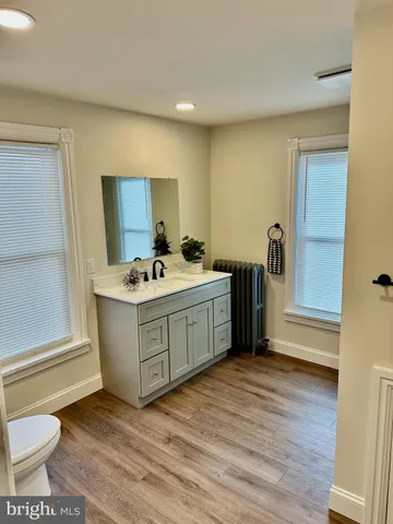 a kitchen with a sink cabinets and a wooden floor