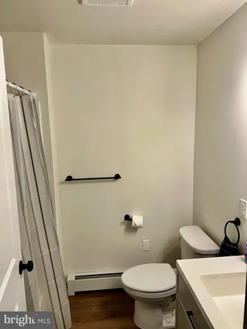 a white toilet sitting next to a small sink