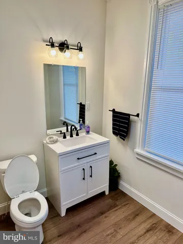 a bathroom with a sink toilet and mirror
