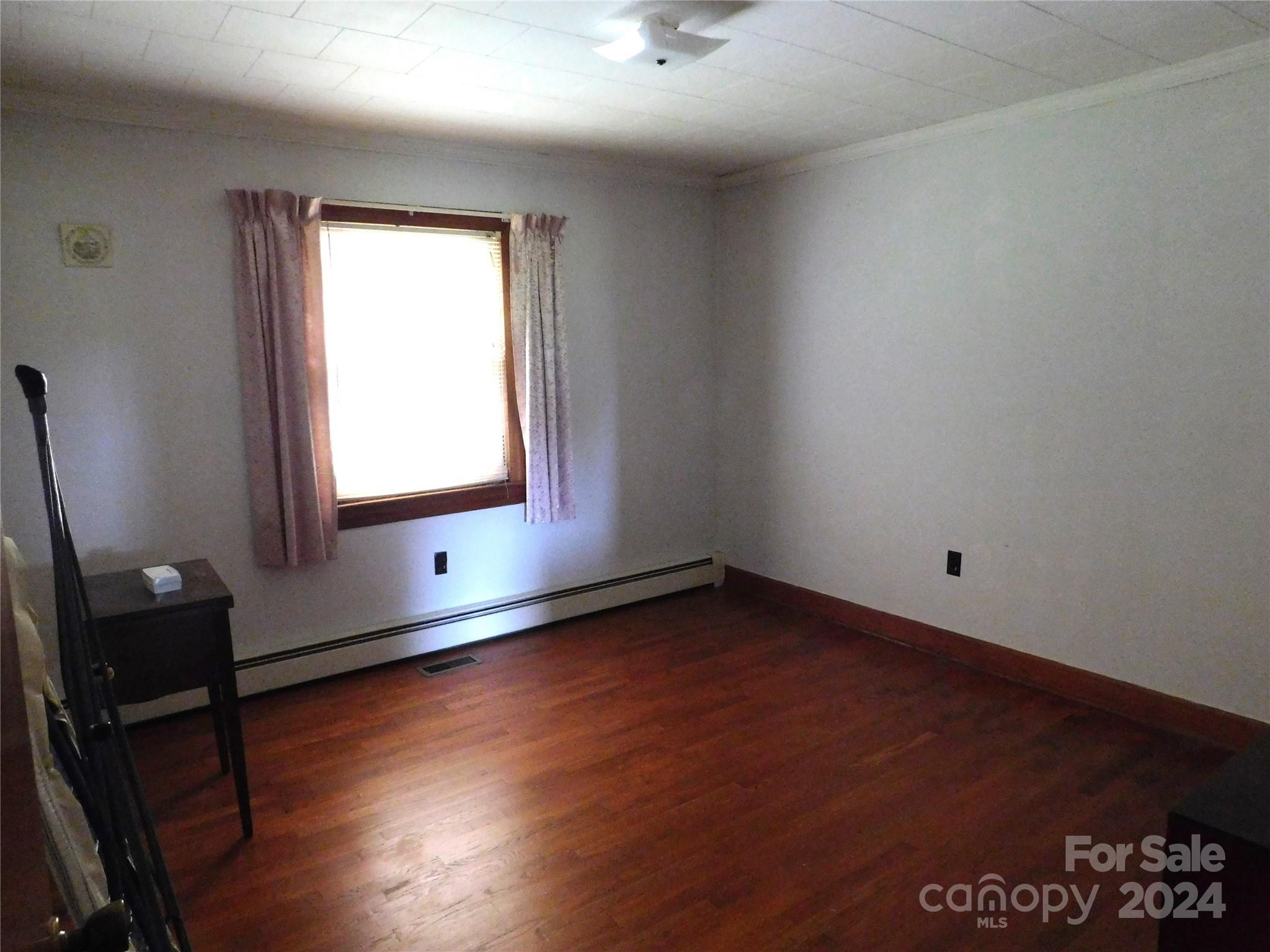 175 Fairmount Road Statesville, NC 28625 - Photo 27 of 30 a view of an empty room with wooden floor and a window