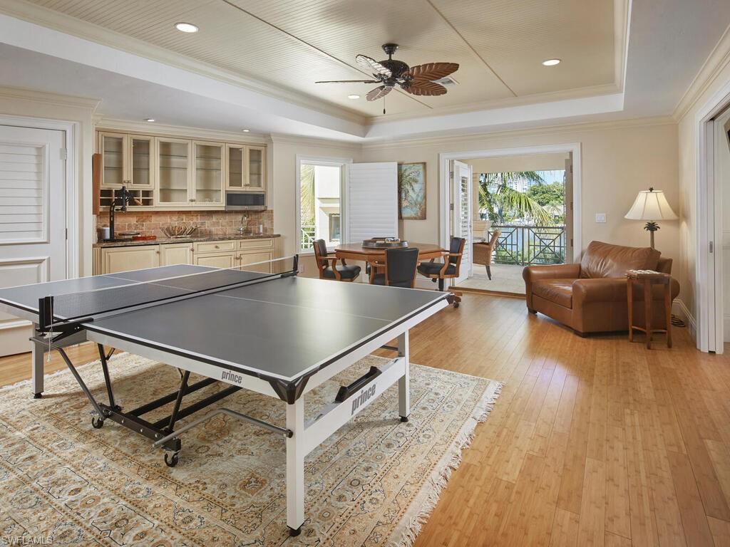 377 Pirates Bight Naples, FL 34103 - Photo 25 of 44 a living room with a table furniture and a window