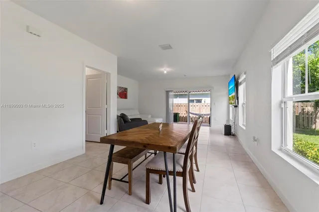 a view of a dining room with furniture and a window