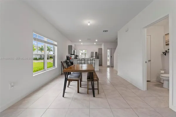 a dining room with furniture and a window