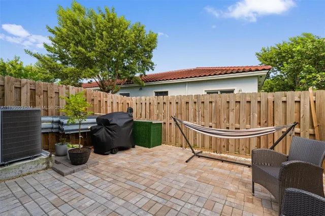 a view of a chair and tables back yard of the house