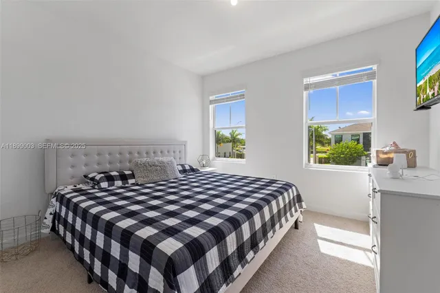 a bedroom with a large bed and a window