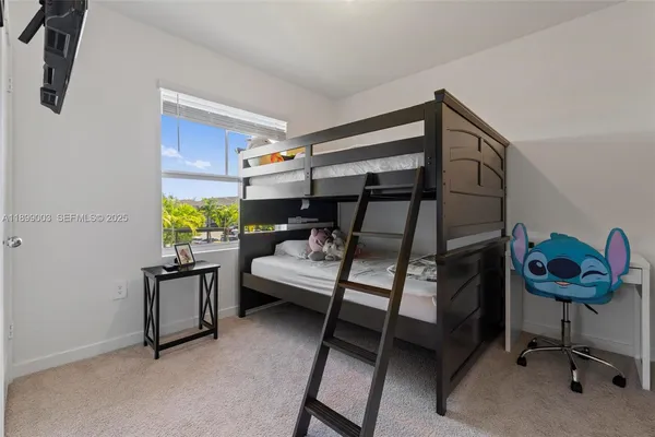 a bedroom with furniture and a window