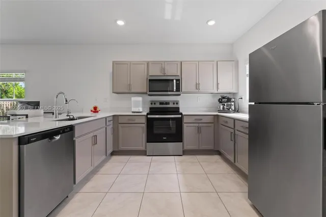 a kitchen with a sink a stove and refrigerator
