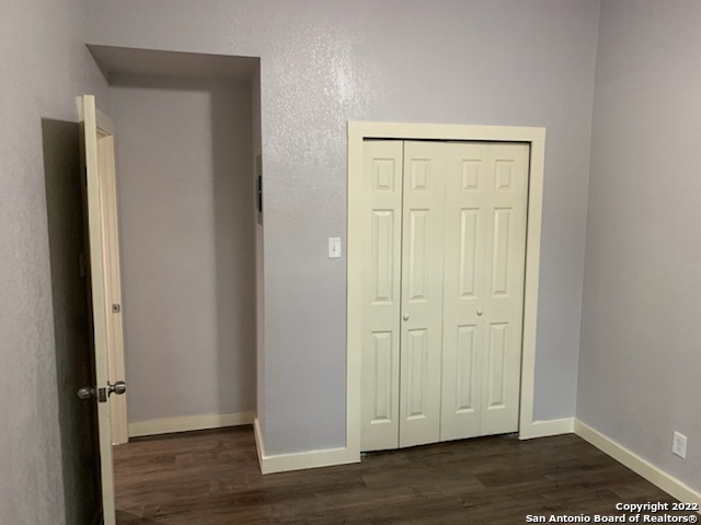 520 Gentleman Road, Unit 4 Balcones Heights, TX 78201 - Photo 6 of 13 an empty room with wooden floor and closet