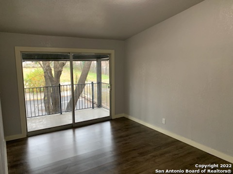 520 Gentleman Road, Unit 4 Balcones Heights, TX 78201 - Photo 7 of 13 a view of an empty room with wooden floor and a window