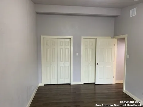 a view of an empty room and wooden floor