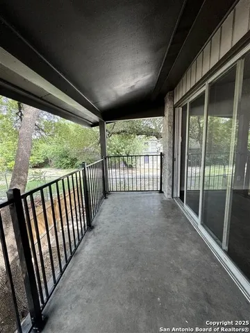 a view of porch with green trees