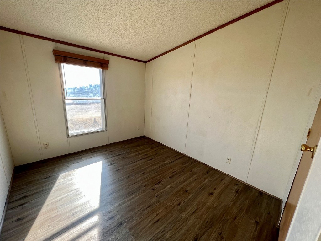 7429 Remington Road Como, CO 80432 - Photo 13 of 21 a view of an empty room with wooden floor and a window