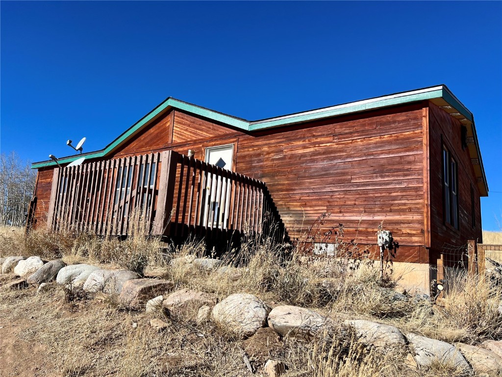 7429 Remington Road Como, CO 80432 - Photo 2 of 21 a front view of a house with a yard