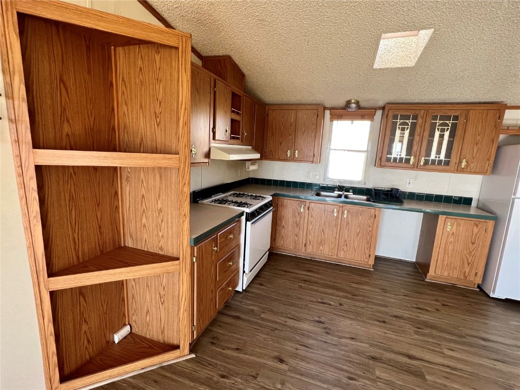 7429 Remington Road Como, CO 80432 - Photo 5 of 21 a kitchen with granite countertop wooden cabinets and a stove top oven