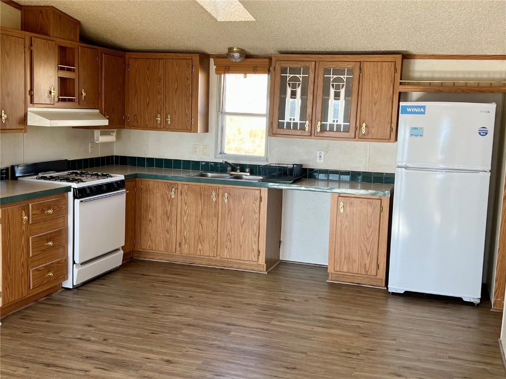 7429 Remington Road Como, CO 80432 - Photo 6 of 21 a kitchen with stainless steel appliances granite countertop a stove a sink and a refrigerator